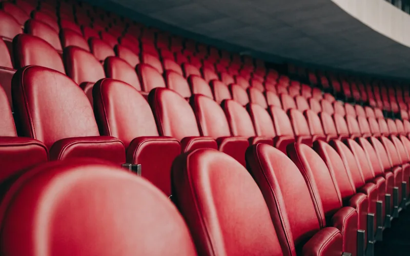 Rows of empty red stadium seats